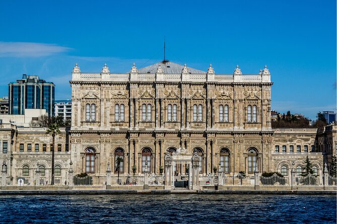 Bosphorus Evening Cruise: Dinner, Live Shows & Private Table - Dolmabahçe Palace glowing beside the water